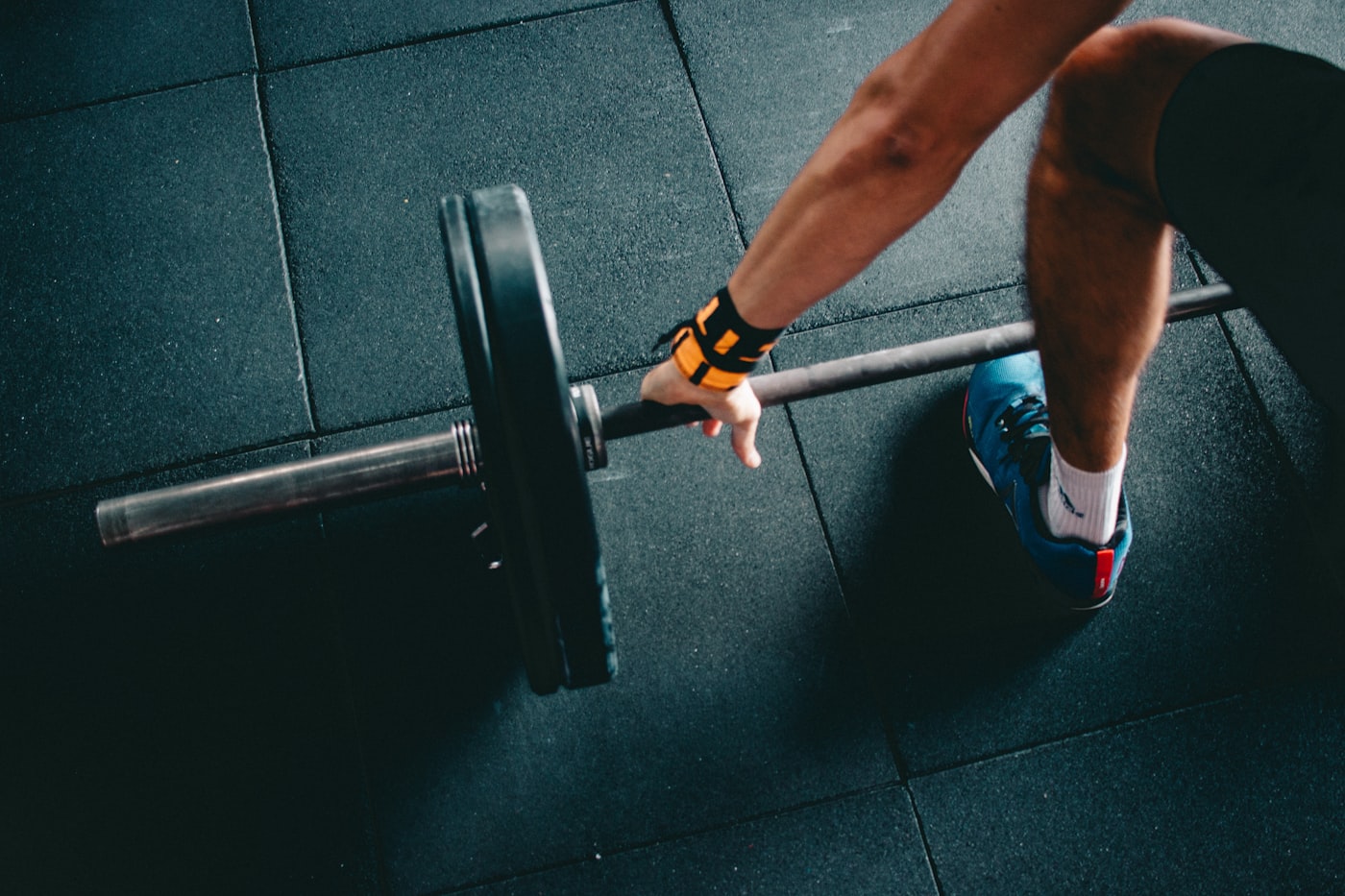An athlete gripping a loaded barbell