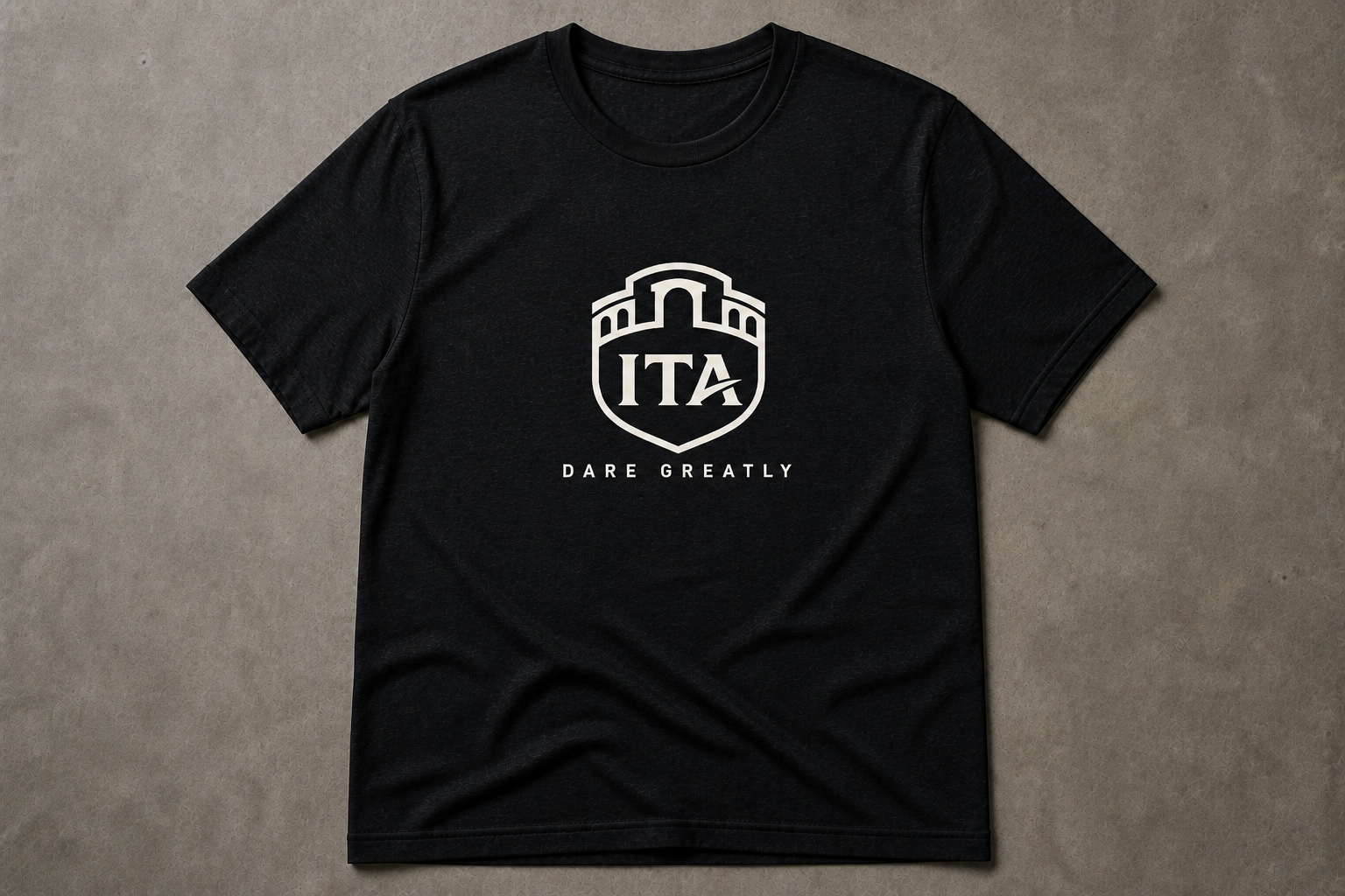The Crest Tee in black triblend, cream ITA lockup on the chest